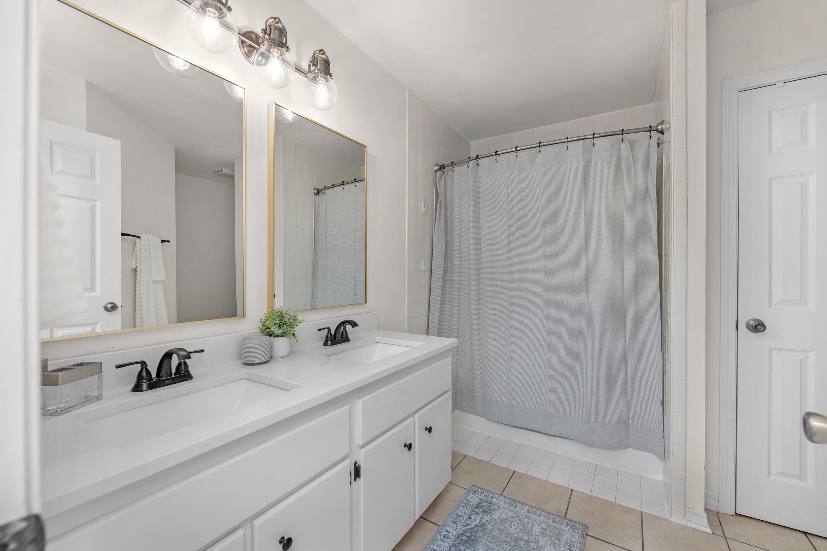 2709 Augustus Road Navarre, FL 32566 - Photo 33 of 46 a bathroom with a double vanity sink and a mirror