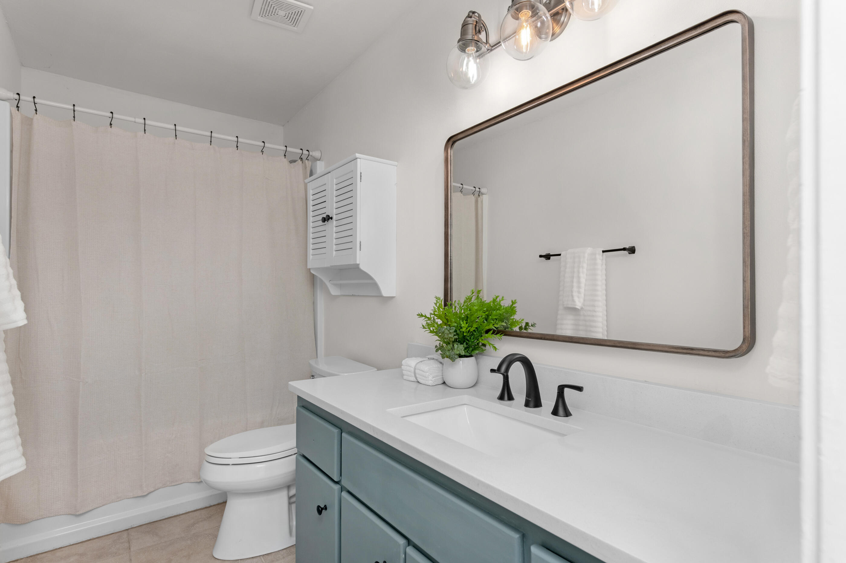 2709 Augustus Road Navarre, FL 32566 - Photo 39 of 46 a bathroom with a sink a toilet and a mirror