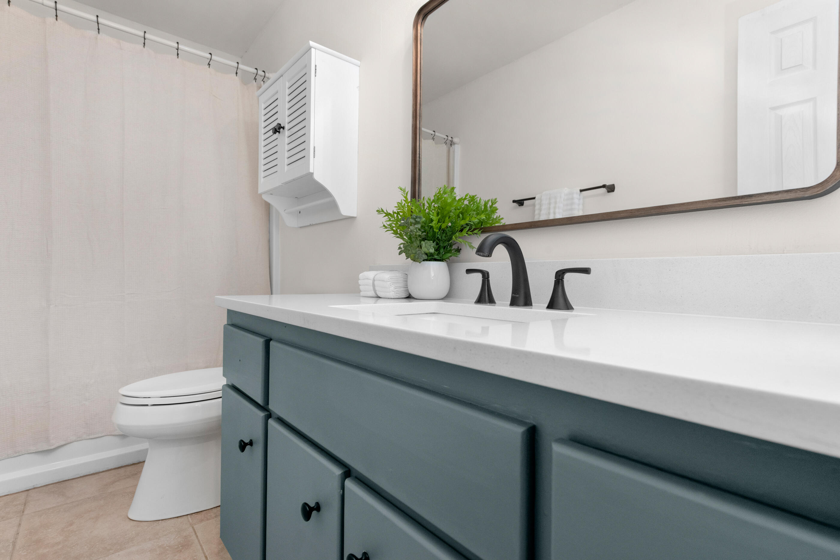 2709 Augustus Road Navarre, FL 32566 - Photo 40 of 46 a bathroom with a sink a toilet and mirror