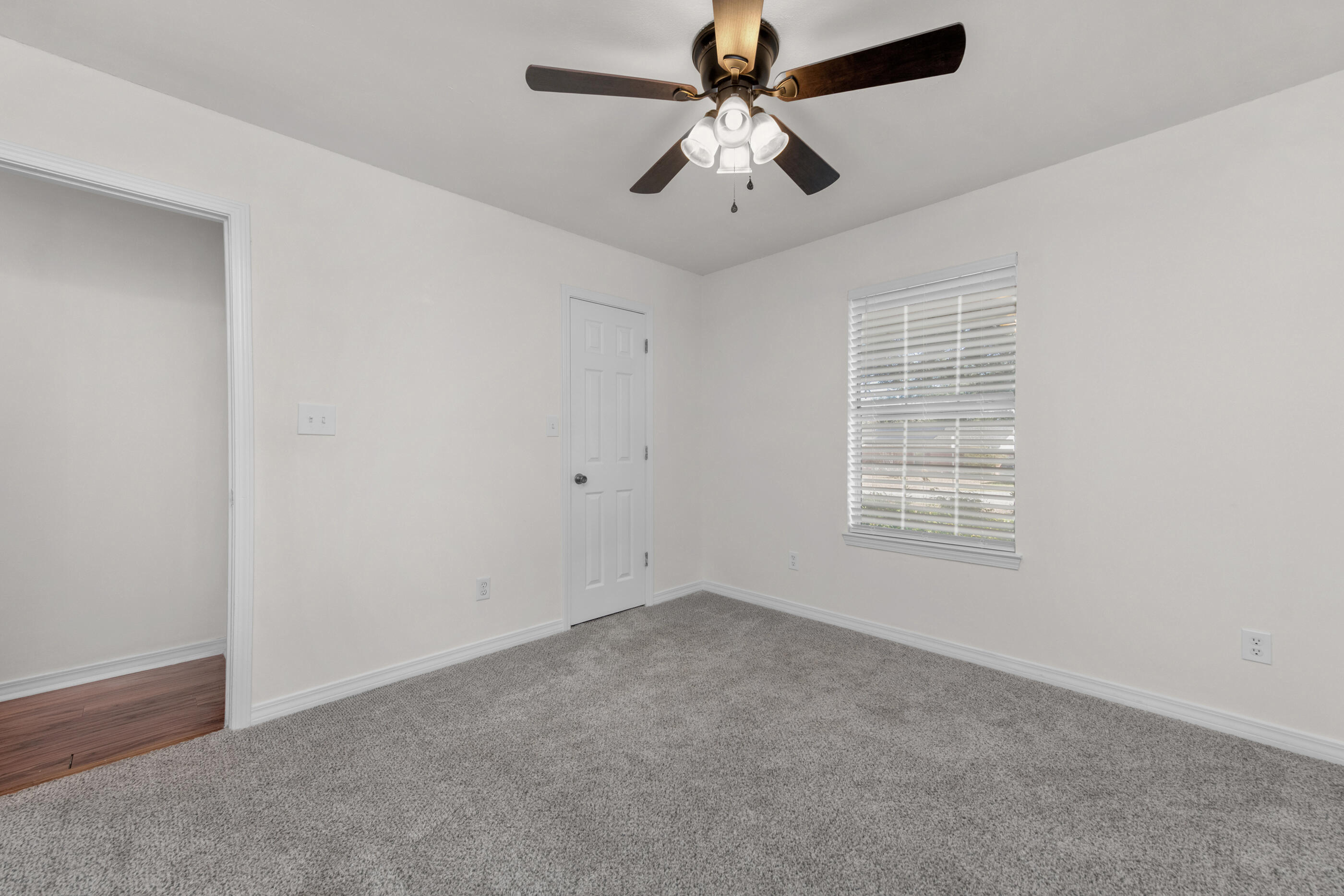 2709 Augustus Road Navarre, FL 32566 - Photo 42 of 46 an empty room with a window and a fan