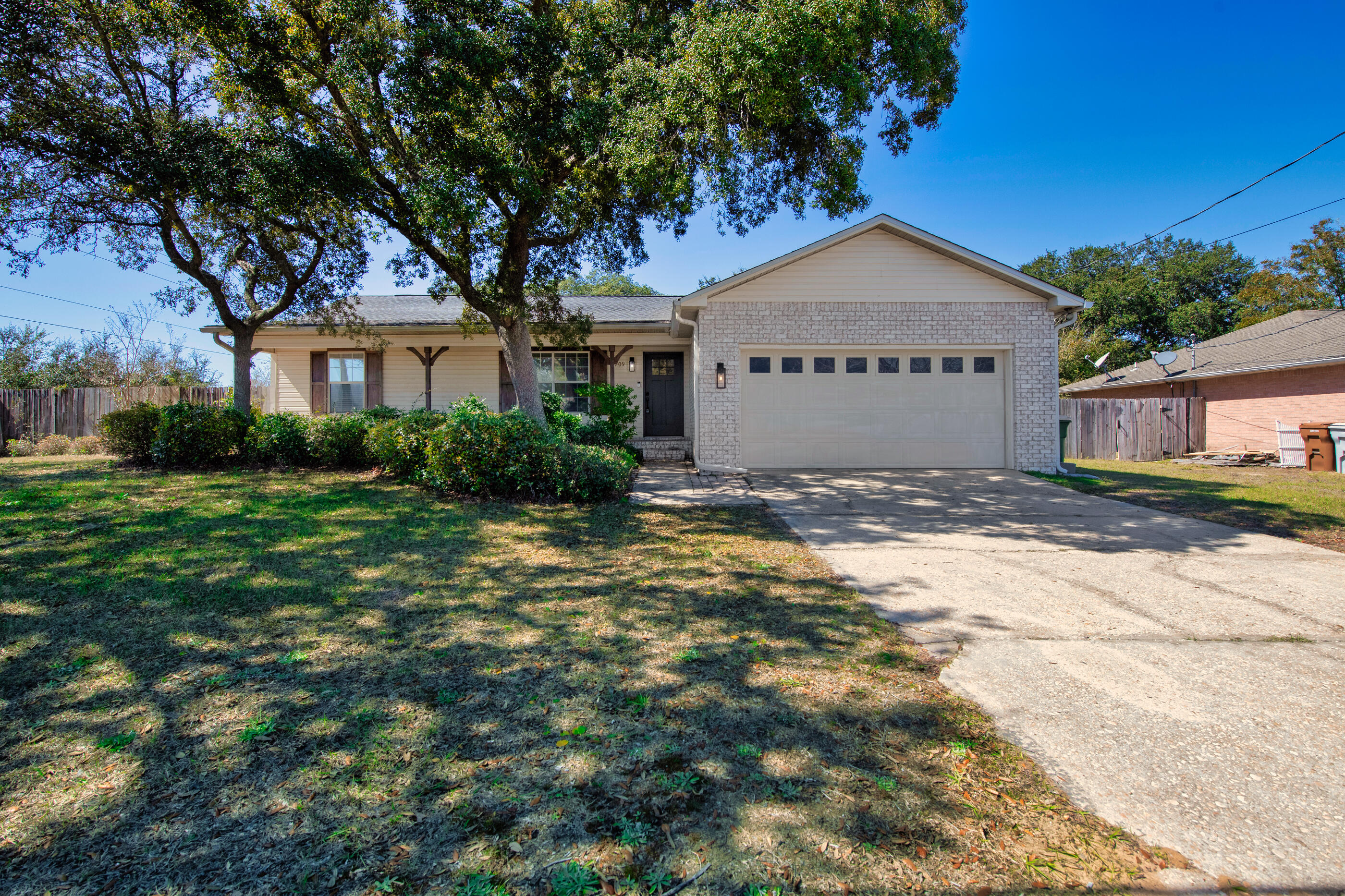 2709 Augustus Road Navarre, FL 32566 - Photo 43 of 46 a view of a house with a small yard and large tree