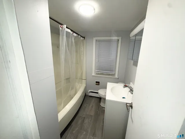 a view of a kitchen with fridge and workspace