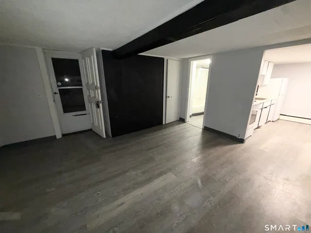 a kitchen with stainless steel appliances a stove a microwave and a hard wood floors