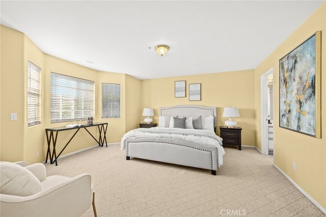 a spacious bedroom with a bed and a couch