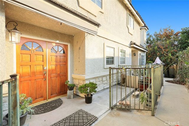 a view of a balcony with potted plants