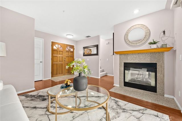 a living room with furniture a fireplace and a table