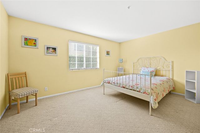 a bedroom with a bed and a chair