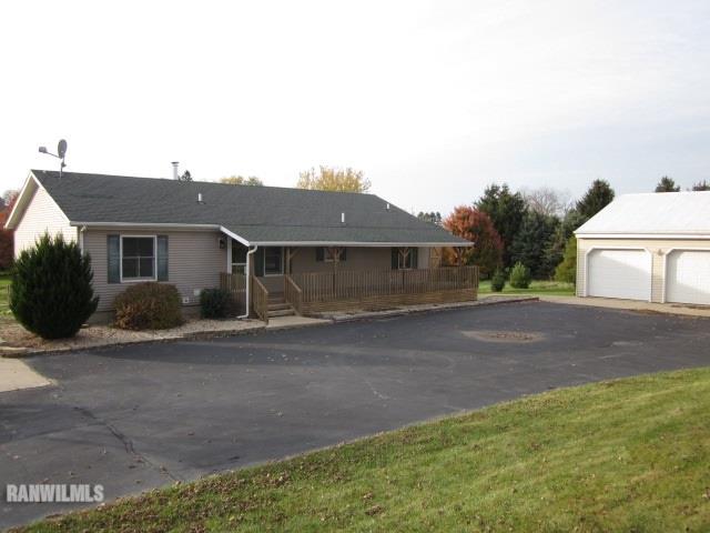7264 East German Valley Road German Valley, IL 61039 - Photo 2 of 25 a front view of a house with a yard and garage