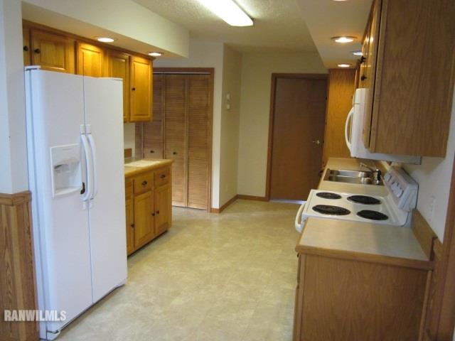 7264 East German Valley Road German Valley, IL 61039 - Photo 5 of 25 a kitchen with a refrigerator a stove and a sink