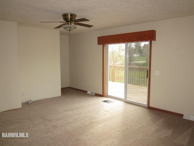 7264 East German Valley Road German Valley, IL 61039 - Photo 10 of 25 a view of a room with a ceiling fan and a large window