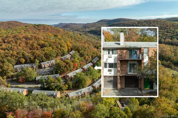 an aerial view of residential houses with outdoor space and ocean view