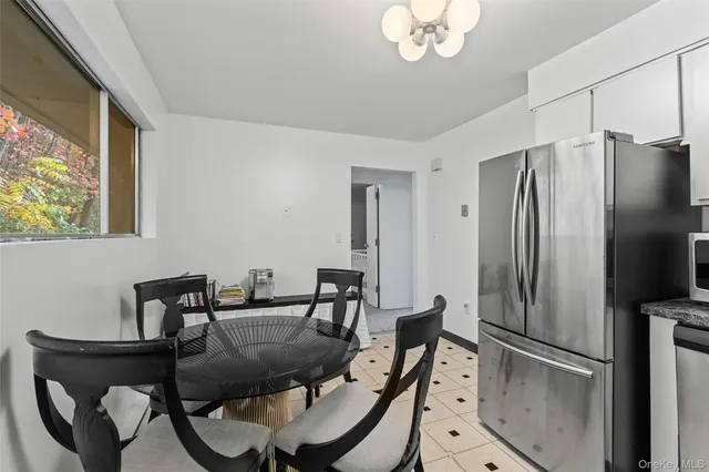 a large bed sitting in a bedroom next to a window