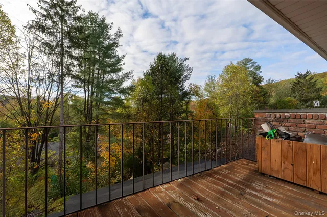 a view of a balcony with wooden floor and fence