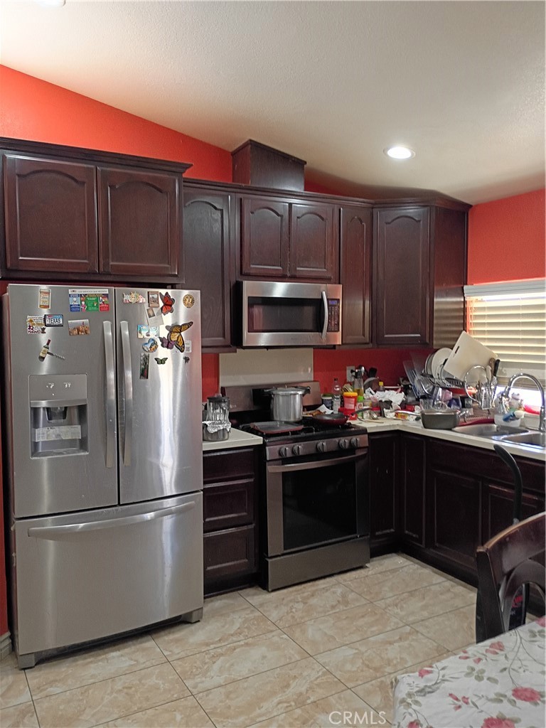 14724 Cypress Road Adelanto, CA 92301 - Photo 6 of 8 a kitchen with stainless steel appliances granite countertop a refrigerator stove and microwave