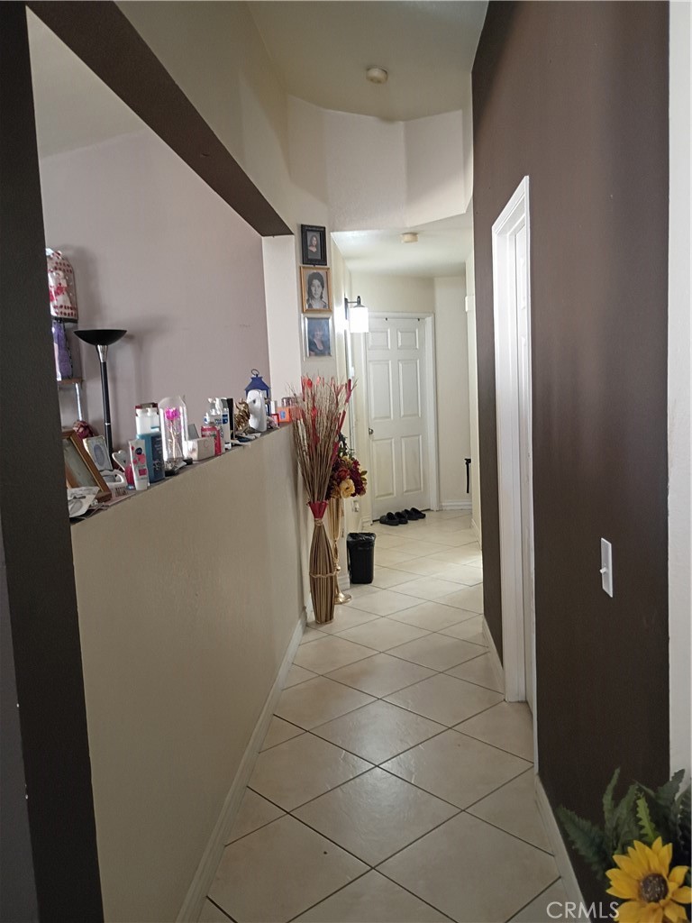 14724 Cypress Road Adelanto, CA 92301 - Photo 8 of 8 a view of a hallway with closet and a potted plant