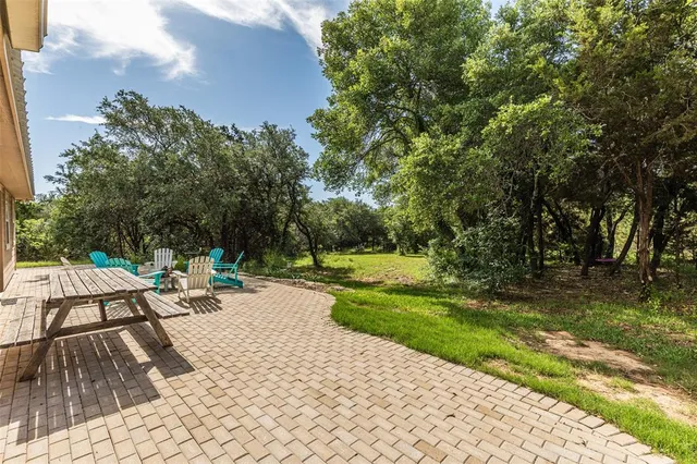 a view of a backyard with sitting area