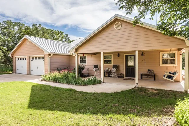 a view of a house with a yard patio and swimming pool