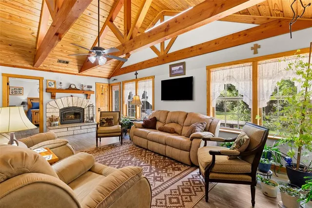a living room with furniture a fireplace and a flat screen tv