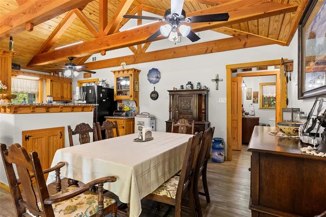 a view of a dining room with furniture and a chandelier