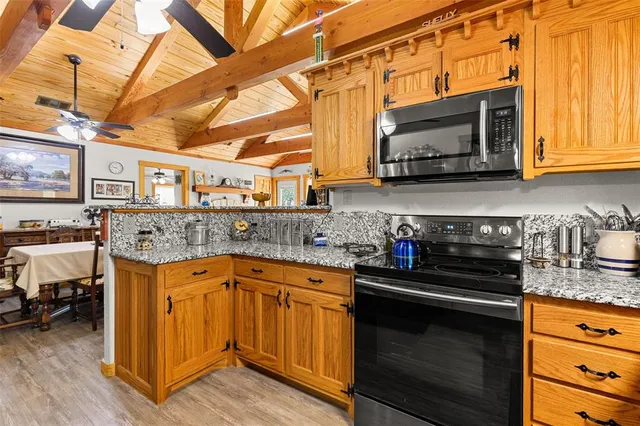 a kitchen with stainless steel appliances granite countertop a stove and a microwave