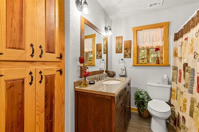 a bathroom with a sink a toilet and a mirror