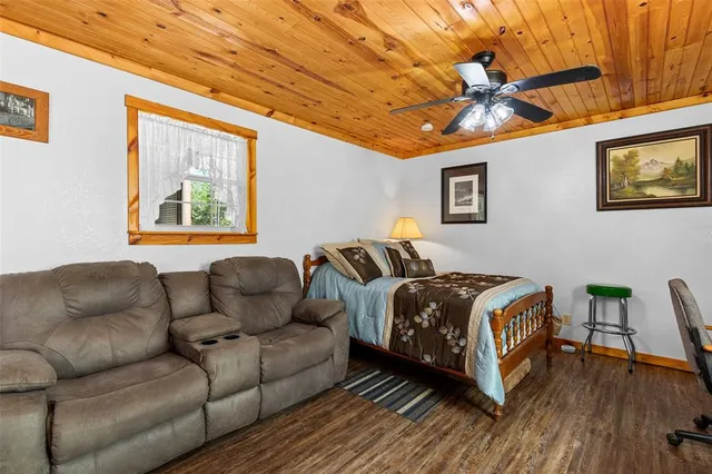 a bedroom with furniture and a wooden floor