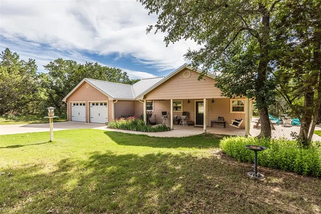 a front view of a house with swimming pool having outdoor seating