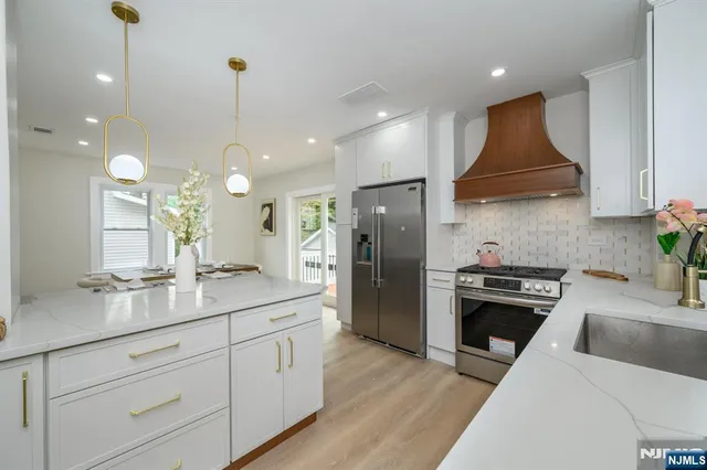 a kitchen with a sink stainless steel appliances and cabinets
