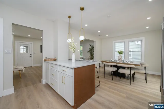 a kitchen with kitchen island granite countertop a sink table and chairs