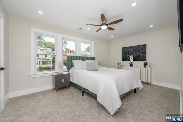 a bed room with a bed and a flat tv screen