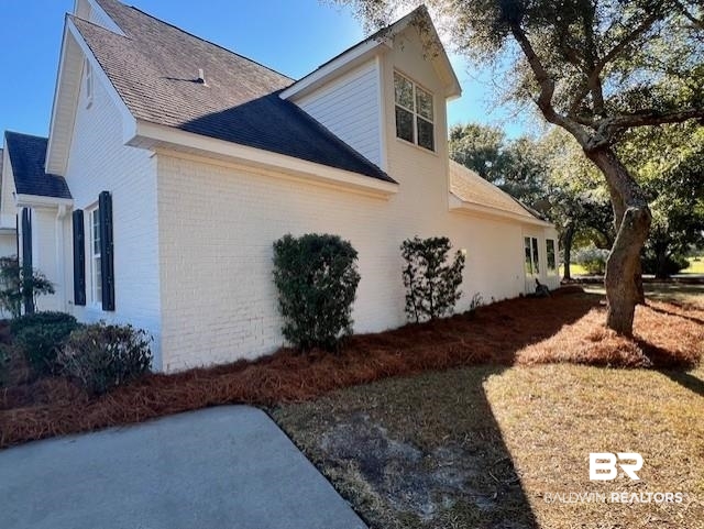 404 Peninsula Boulevard Gulf Shores, AL 36542 - Photo 37 of 51 View of property exterior with brick siding and a shingled roof