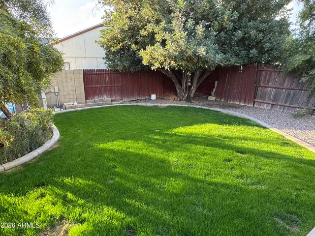 a view of yard with swimming pool and trees