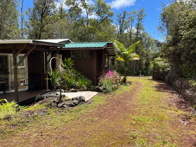 a view of a porch with furniture and a yard