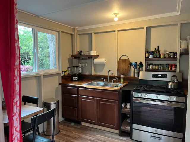 a kitchen with stainless steel appliances a stove a sink and a cabinets