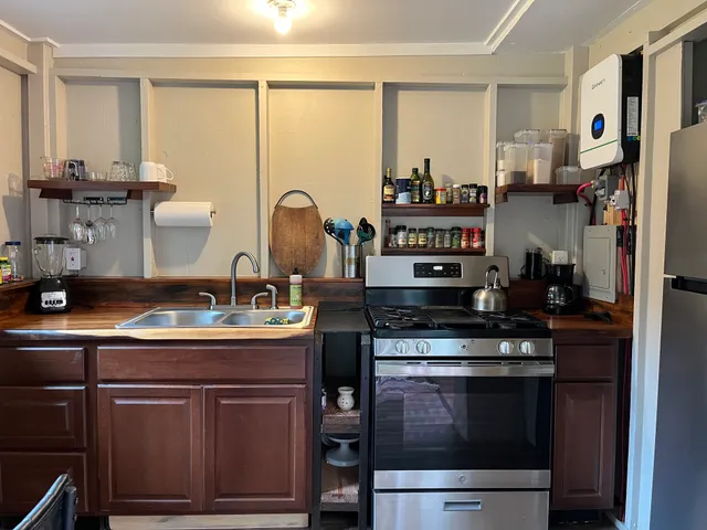 a kitchen with stainless steel appliances granite countertop a stove and cabinets