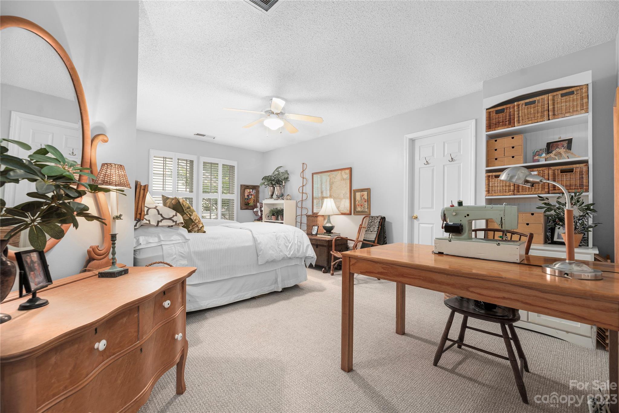 13328 Sloe Way Huntersville, NC 28078 - Photo 18 of 32 a room with a bed a table and a potted plant
