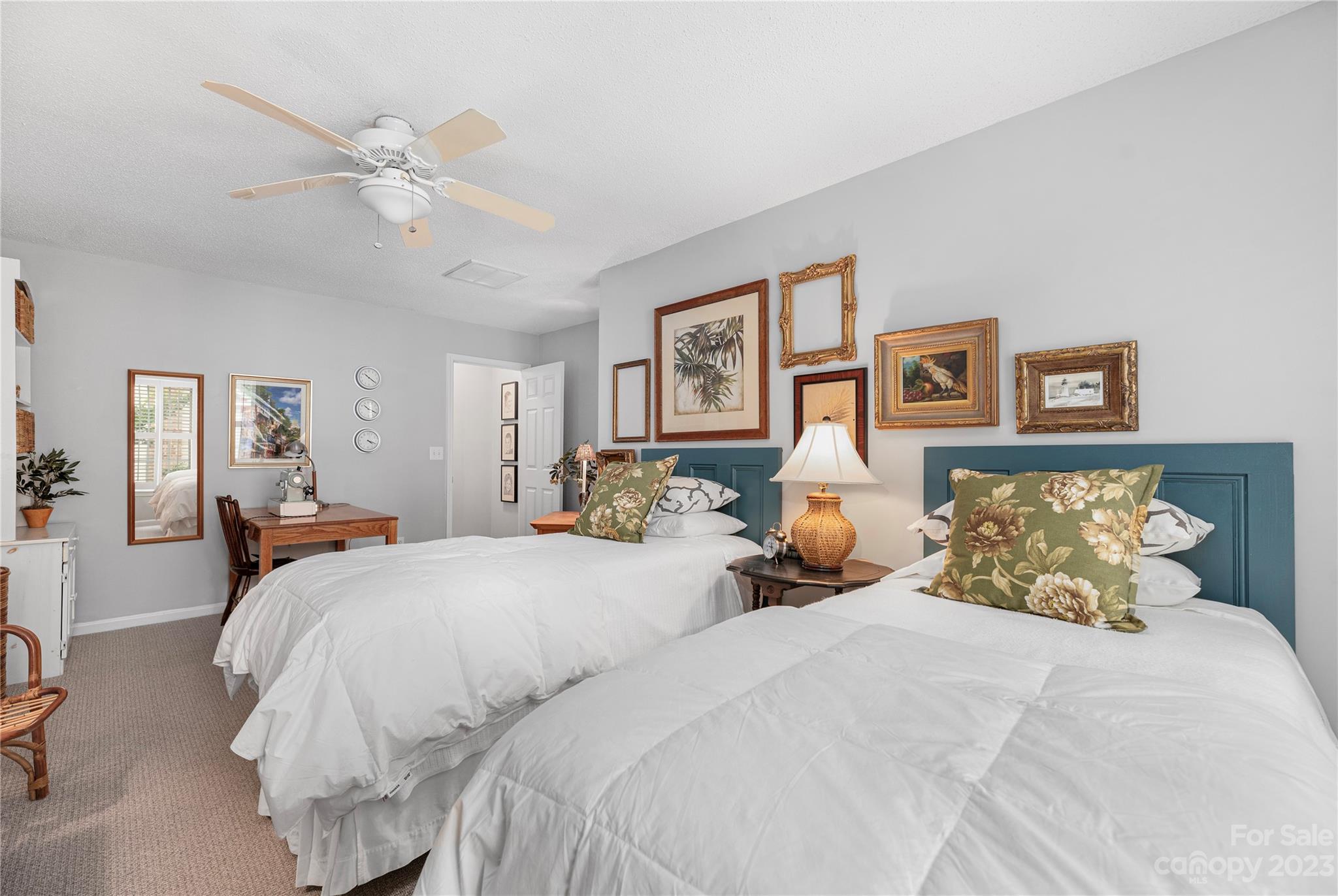 13328 Sloe Way Huntersville, NC 28078 - Photo 20 of 32 a bed room with two bed and paintings on the wall