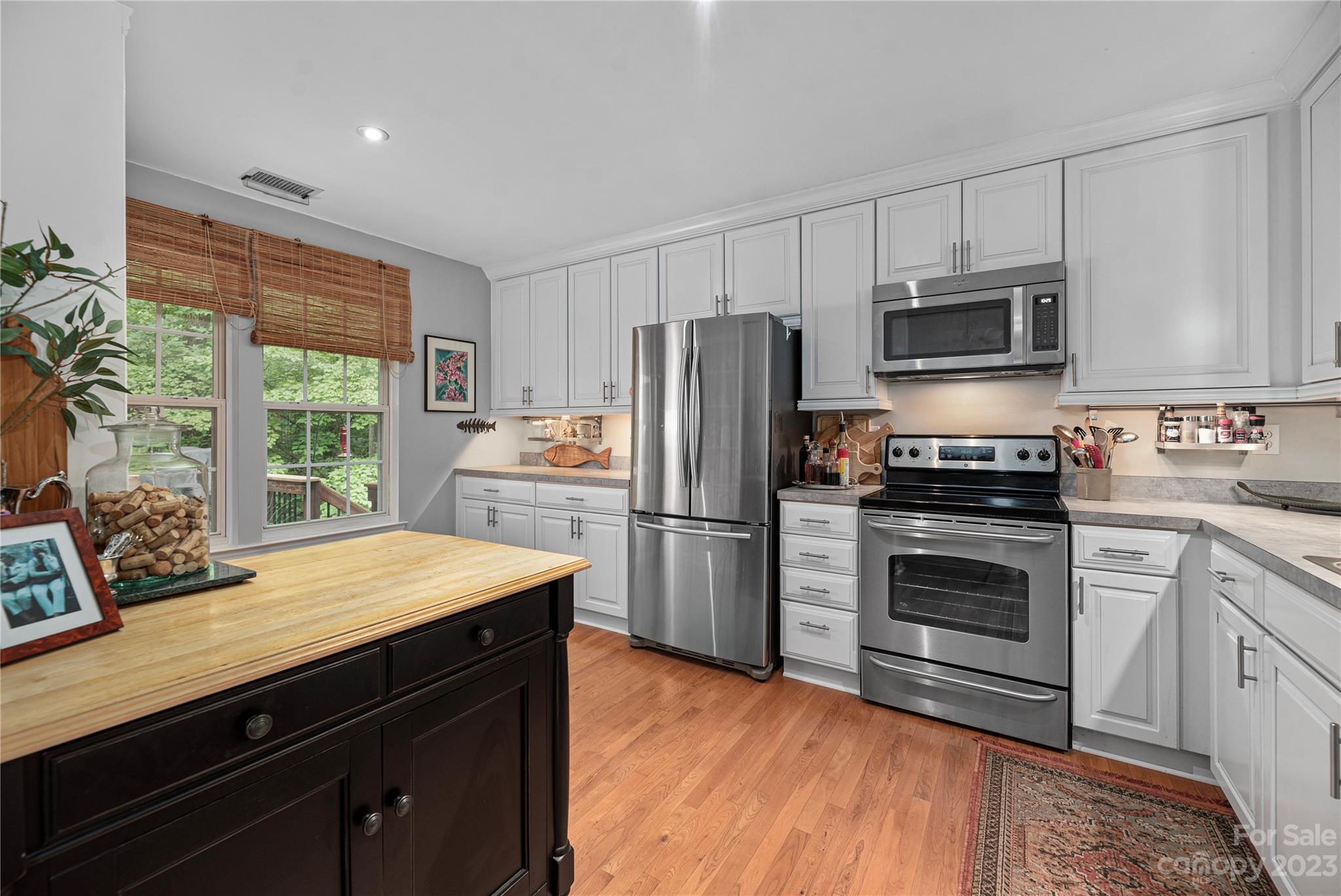13328 Sloe Way Huntersville, NC 28078 - Photo 7 of 32 a kitchen with a refrigerator and a stove top oven