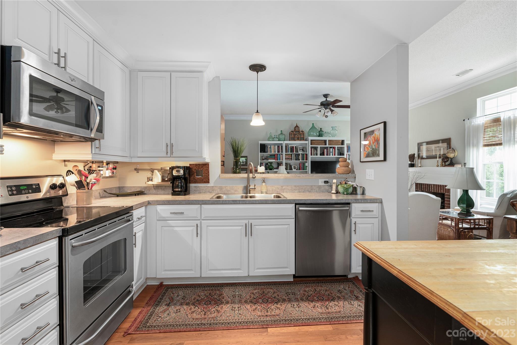 13328 Sloe Way Huntersville, NC 28078 - Photo 8 of 32 a kitchen with a sink stove and microwave