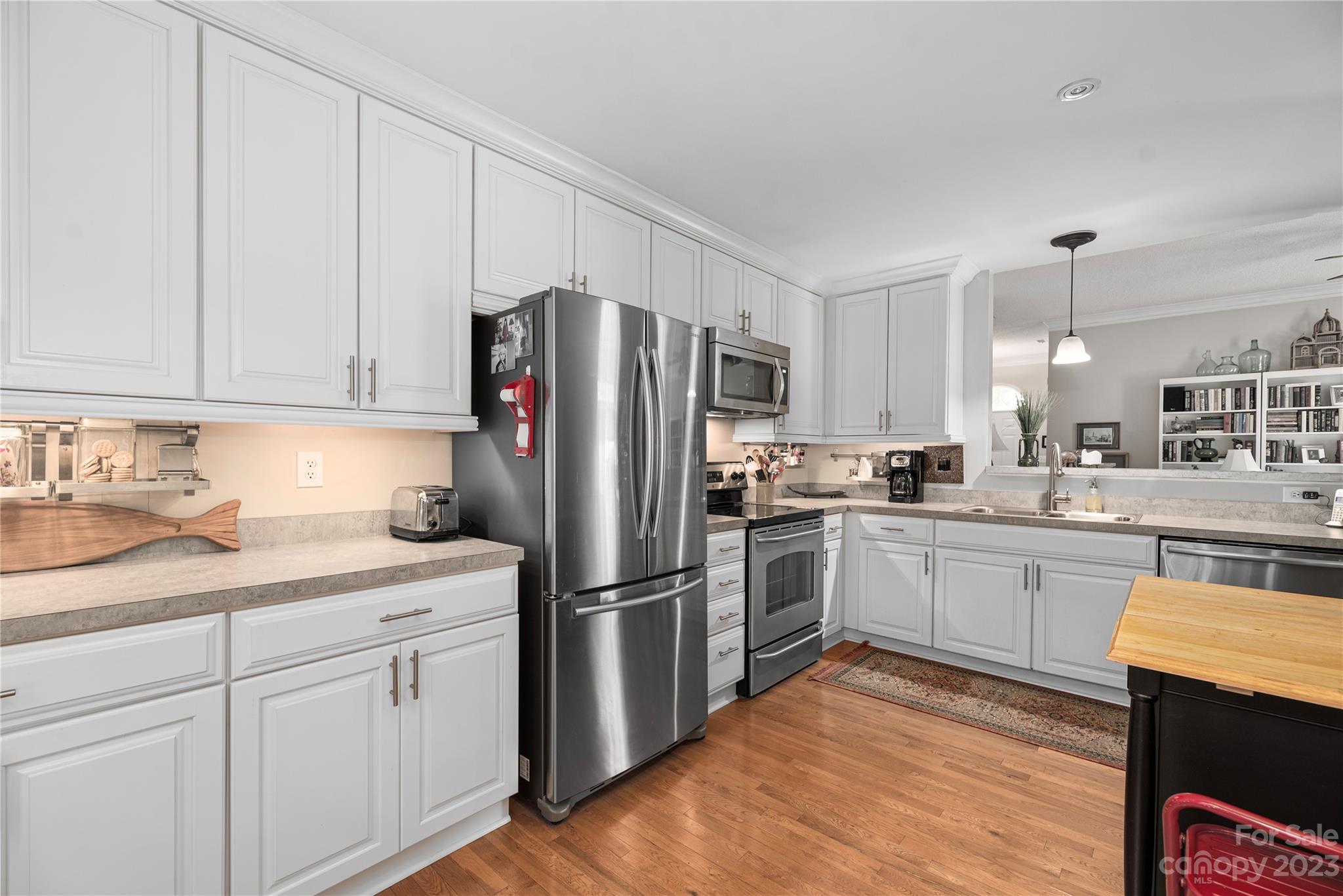 13328 Sloe Way Huntersville, NC 28078 - Photo 9 of 32 a kitchen with a sink stainless steel appliances and white cabinets