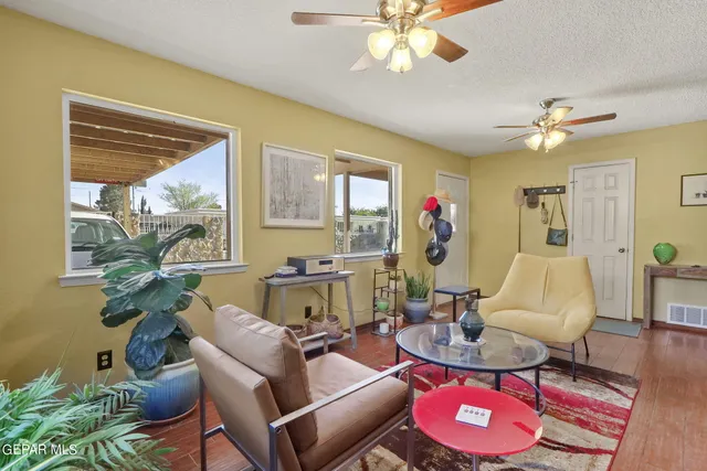 a kitchen with stainless steel appliances granite countertop a stove top oven a sink dishwasher a dining table and chairs with wooden floor