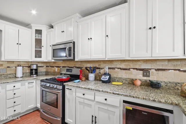 a living room with furniture and a book shelf