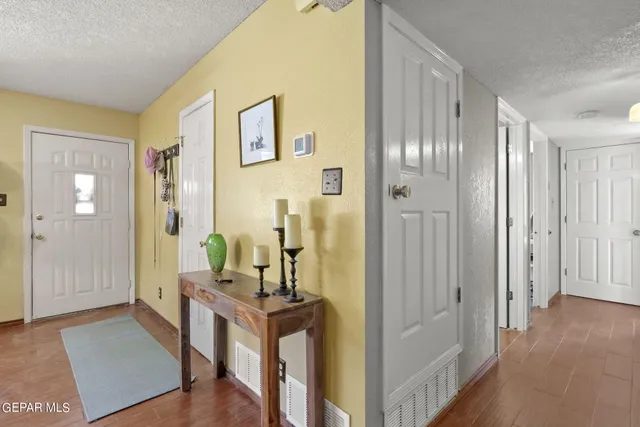 a bedroom with a bed and a dresser next to a window