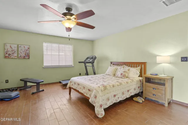 a bedroom with a bed and painting on the wall