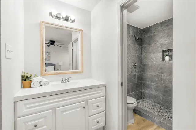 a bathroom with a sink a toilet and shower