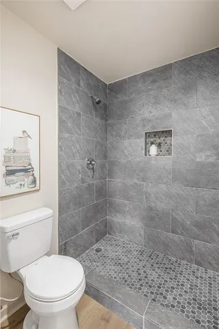 a bathroom with a toilet and a shower