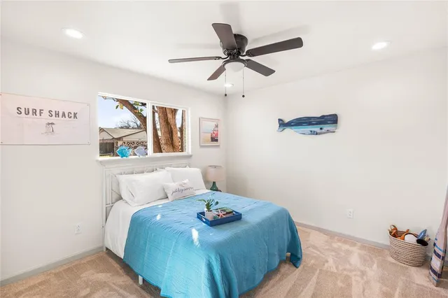 a bedroom with a bed and painting on the wall