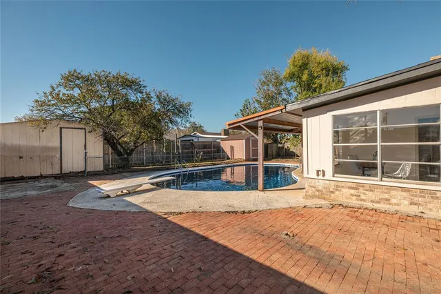 a view of a house with backyard and sitting area