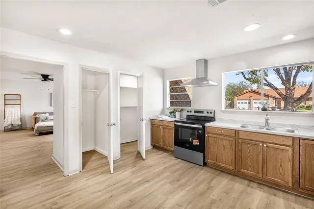 a kitchen with stainless steel appliances granite countertop a stove and a sink