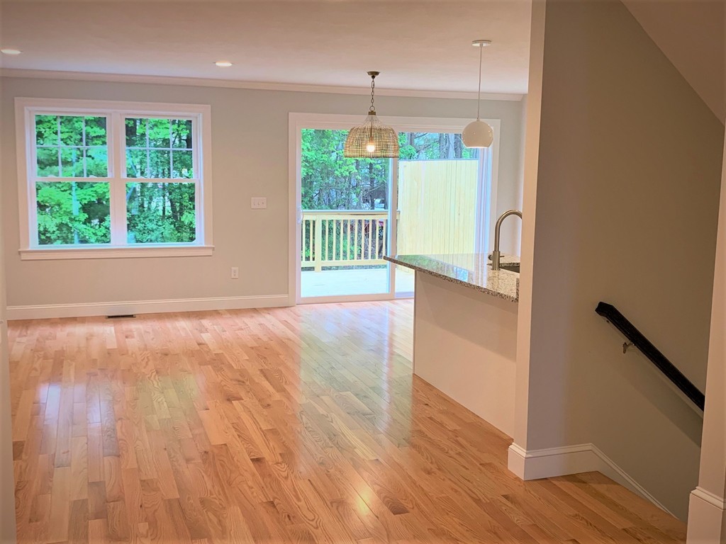 25 Shaker Road, Unit B Ayer, MA 01432 - Photo 5 of 16 a view of an empty room with wooden floor and a window